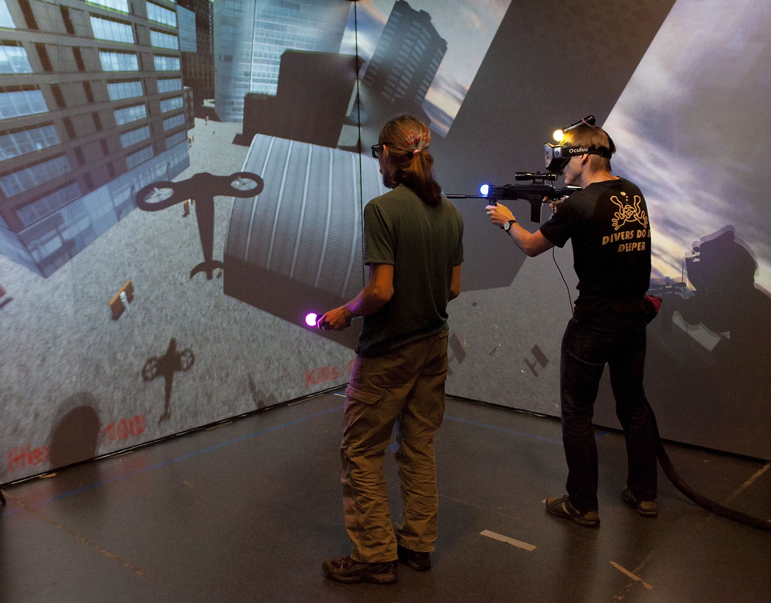 A two player co-operative game, where the player with Oculus Rift and a rifle sneaks around a city, using a laser to light up targets which can be destroyed by the second player who pilots an attack helicopter.