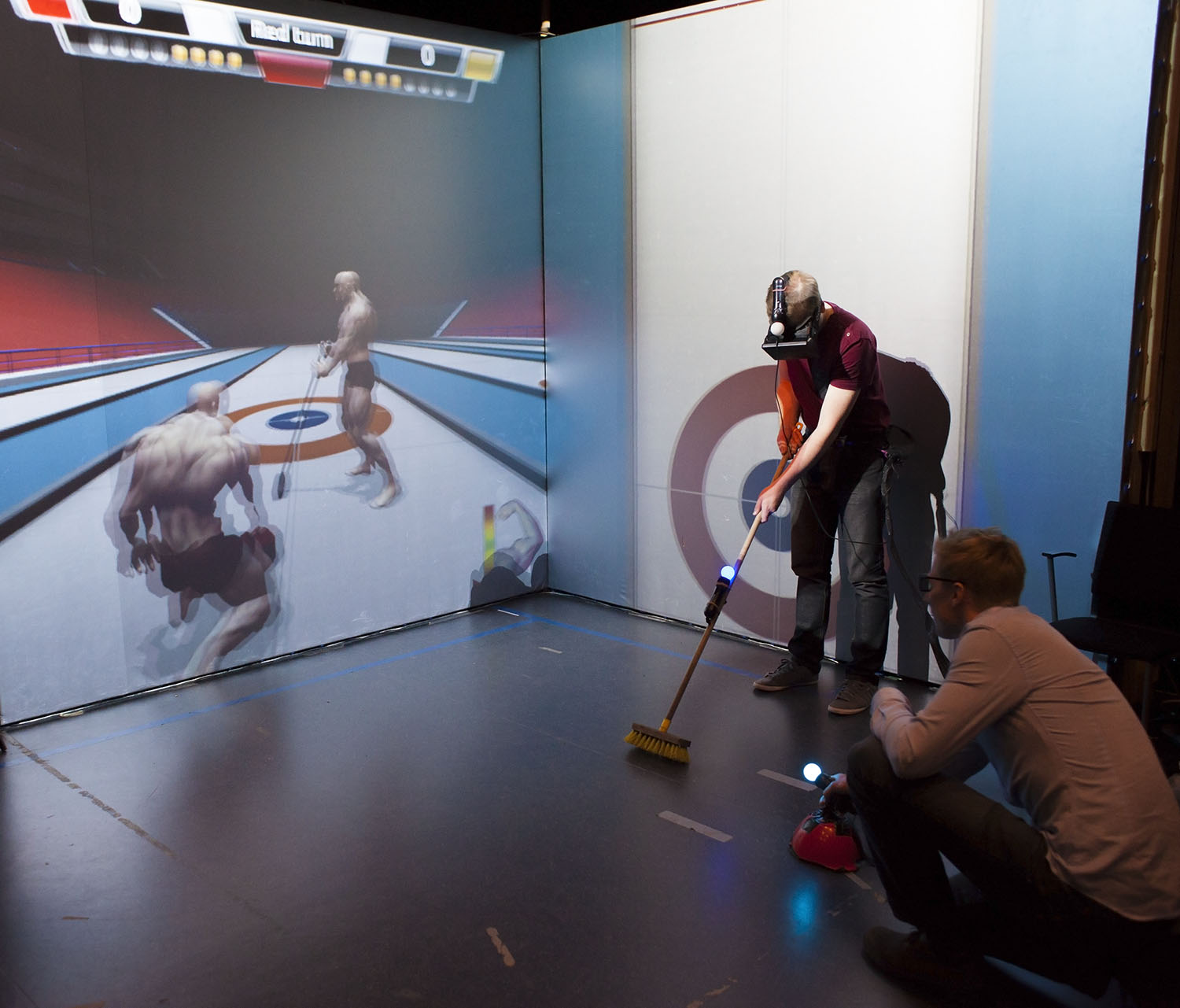 Two player co-operative curling simulator where one player is a curler who "throws" stones, and the another player acts as a sweeper, affecting the trajectory of the stones while it slides on ice.